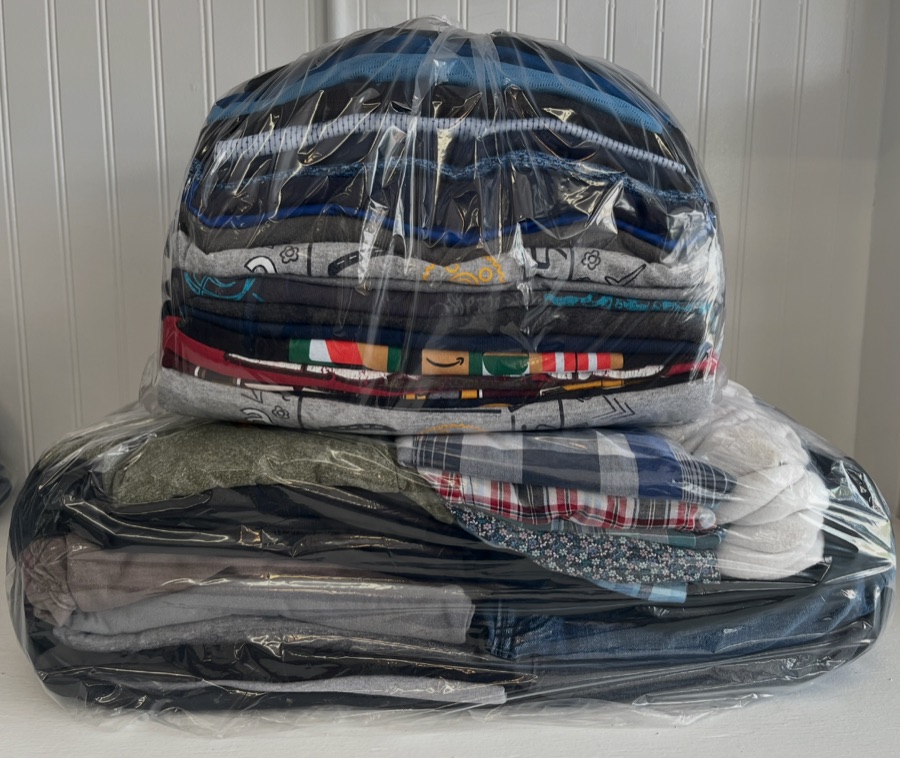 Neatly folded laundry, washed, dried, and packaged for pickup